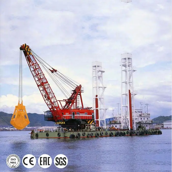 Hydraulic port crane on barge in harbor