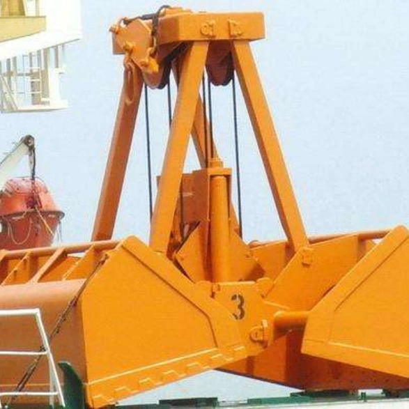 Orange peel gripper bucket attached to a large excavator, showing scale